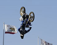 Photo of Nate Adams turning a backflip at X Games X.