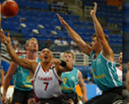 Disabled athletes play wheelchair basketball at 2004 Paralympics.