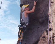 Athlete rock climbs using prosthetic legs.