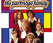 Shirley Partridge and her kids tour in their big yellow bus.