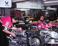 Mechanics tune-up a car for the Indy 500