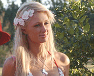 Pin a pretty flower in your hair like Paris Hilton does.
