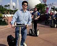 Dean Kamen in Disney World with his scooter invention, the Segway.