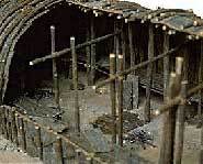 A hallway divided the rooms and a fire was built in the middle.