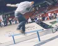 Skateboarder does a rail slide at the 2002 Slam City Jam.