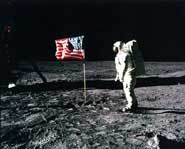 Neil Armstrong, the first man on the moon puts up an American flag.