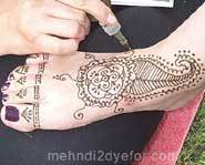 A foot being hennaed.