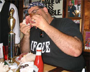 Photo of Cookie Jarvis eating a cornbeef sandwich in an eating contest.