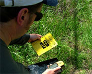 Picture of geocacher discovering a cache.