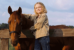 Photo of Dakota Fanning horseback riding in Dreamer.