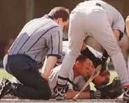 A baseball player gets hit by a pitch.