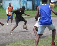 Kids in Africa play with a homemade soccer ball.
