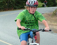 A kid competing in the cycling portion of the Ironkids Triathlon Series.