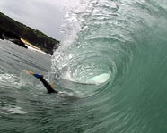 A surfer attempting a duck dive.