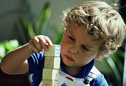 A symptom of autism is obsessively stacking or lining up objects.