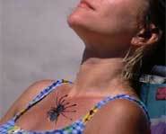 The spider slowly crawls up her.